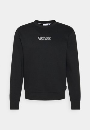 Černá bavlněná mikina s kulatým výstřihem, žebrovanými manžetami a bílým logem "Calvin Klein" na přední straně.
