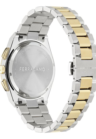 Reloj de acero inoxidable con una pulsera de eslabones en tono plateado y dorado. Presenta un fondo liso, cristal de zafiro y un acabado pulido.