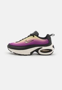 Black sneaker with gradient purple and yellow upper, rounded shape, visible air cushioning in sole, and black laces.