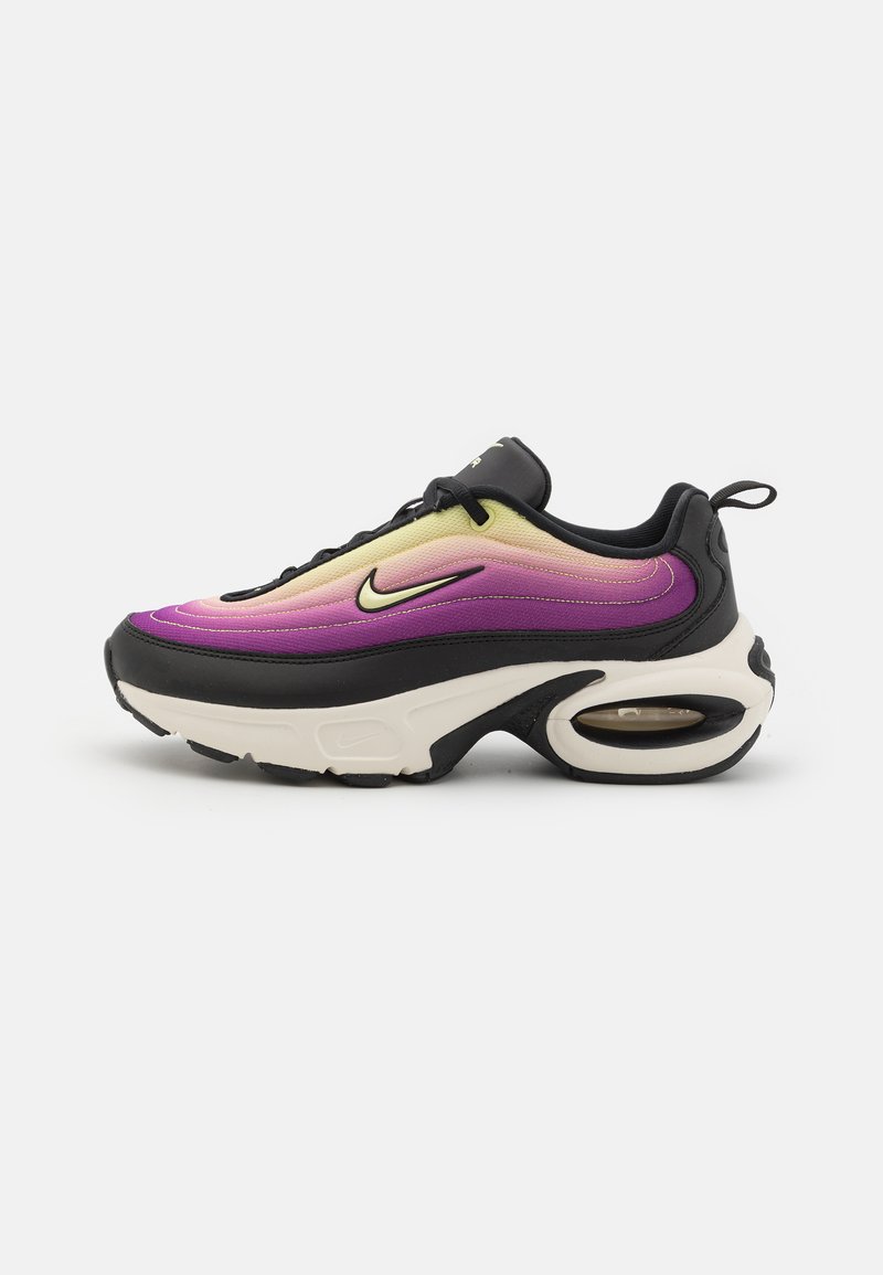 Black sneaker with gradient purple and yellow upper, rounded shape, visible air cushioning in sole, and black laces.