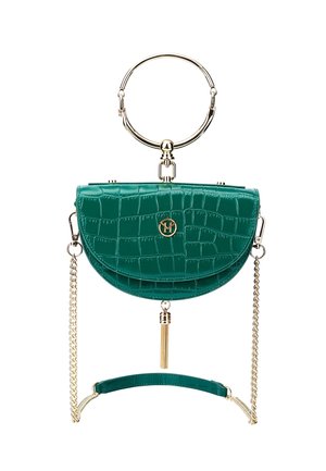 Pochette vert émeraude à motif crocodile avec poignée circulaire dorée, bandoulière chaîne dorée et pompon doré suspendu au centre en bas.