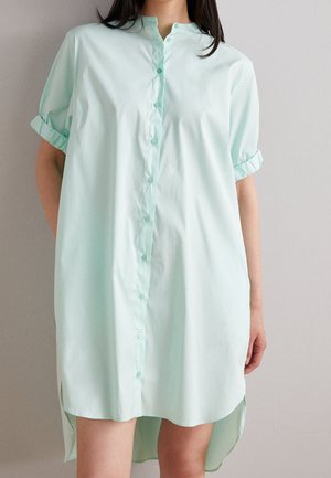 Mintgrünes Hemdkleid mit kurzen, hochgerollten Ärmeln, geradem Schnitt, asymmetrischem Saum und glattem Baumwollstoff.