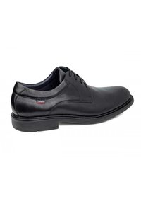 Zapato de vestir de cuero negro con un acabado suave, punta redondeada y detalles de costura sutiles. Cuenta con un bajo tacón de goma y un diseño de cordones.