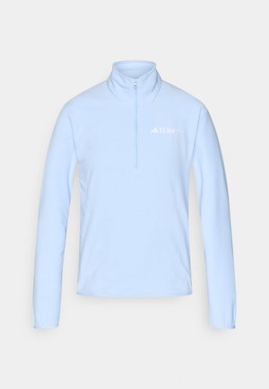 Jasnoniebieska bluza polarowa z zamkiem przy kołnierzu, długimi rękawami i białym logo "TERREX" na lewej piersi. Miękka faktura.