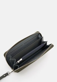 Zippered wallet in olive green, featuring multiple card slots, a zippered compartment, and smooth interior lining. Textured exterior.