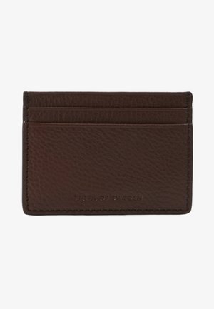 Brown leather cardholder with three card slots, visible stitching, and embossed "Tiger of Sweden" branding on the front.