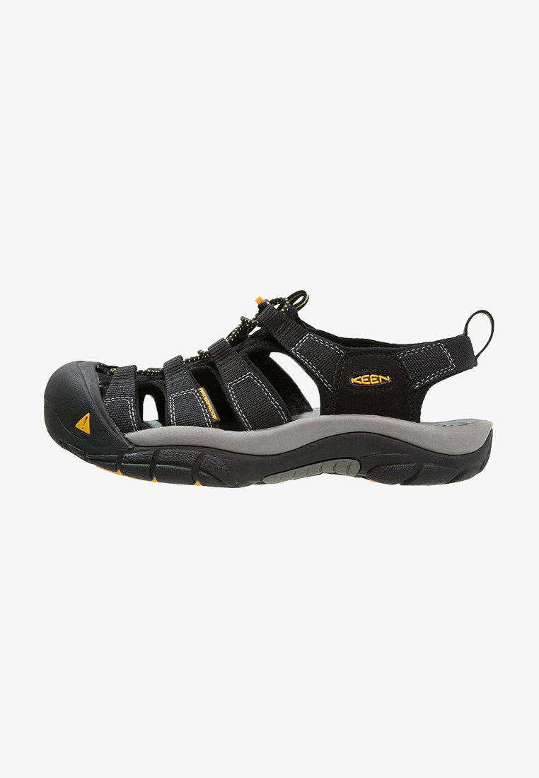 Black sandal with synthetic straps, adjustable lace closure, and a cushioned grey sole. Features rubber toe protection and yellow accents.