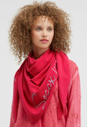 Pink triangular scarf made of soft fabric, featuring silver text accents. Draped stylishly around the neck for a layered look.