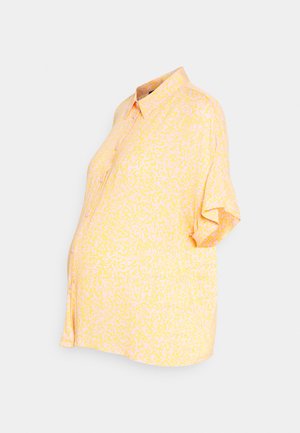 Camisola de maternidade amarela de manga curta com um padrão abstrato branco texturizado. Apresenta uma frente com botões e um corte descontraído para maior conforto.