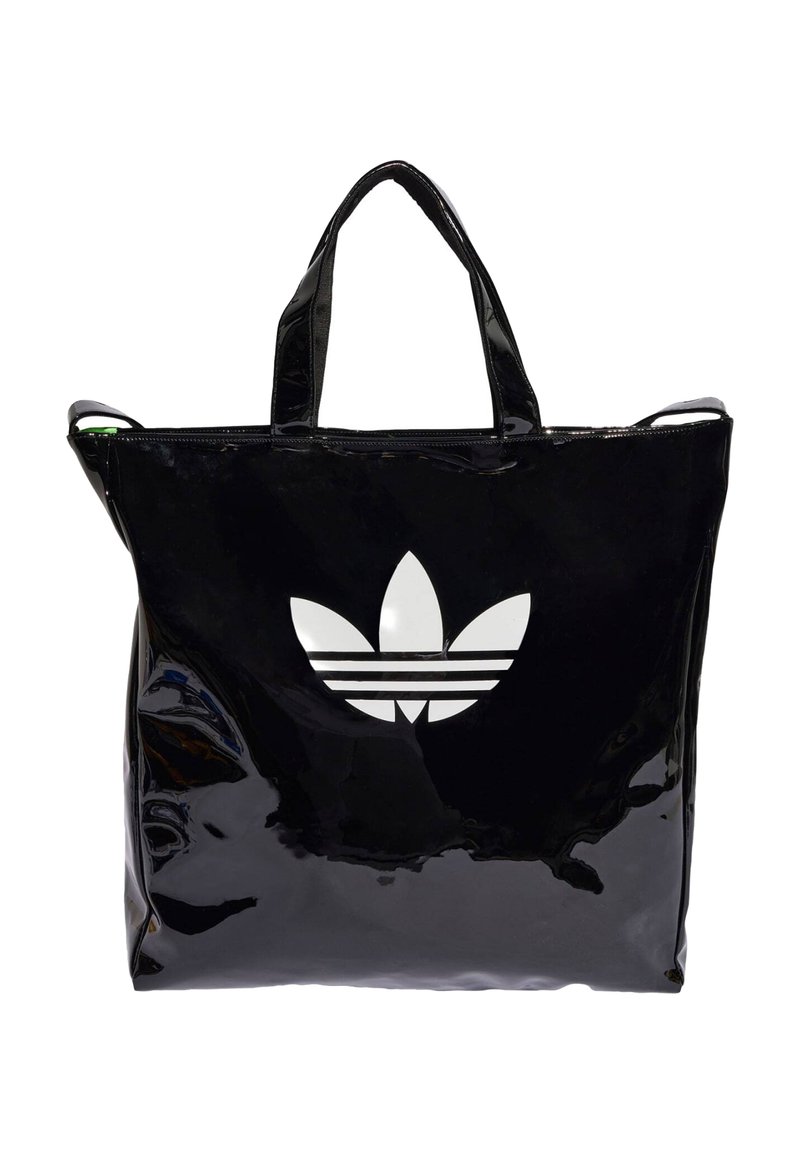 Black patent tote bag with two handles, featuring a large, white Adidas logo and three horizontal stripes on the front.