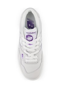 Sneaker bianco New Balance 550 con logo viola, lacci allacciati e collo imbottito, mostrato dall'alto su uno sfondo bianco.