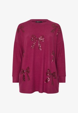 Maglietta a maniche lunghe color mogano con scollo tondo, decorata con diversi fiocchi imbottiti di paillettes di varie dimensioni sul davanti. Tessuto morbido e texture.