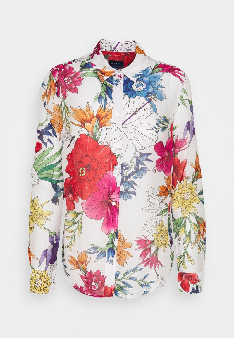 Camisa de flores de mangas largas con fondo blanco y vibrantes flores multicolores, con botones al frente y cuello extendido. Hecha de una tela ligera.