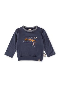 Maglione blu navy con maniche lunghe, colletto a righe e stampa "è magia" in arancione con stelle. Presenta un charm a forma di pinguino sul lato.