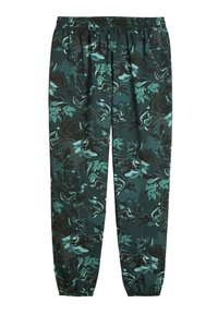 Grønne og sorte mønstrede joggere med elastisk talje og tapered manchetter. Har abstrakte blomster- og bølgemønstre. Glat tekstur.