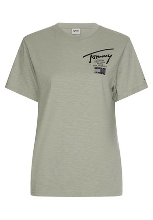 Jasnozielona, krótka koszulka Tommy Jeans z czarnymi nazwami miast i logo nadrukowanymi na górnej lewej części klatki piersiowej.