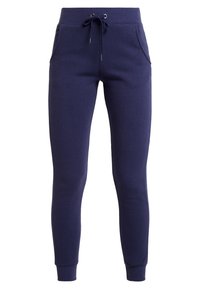 Mörkblå sweatpants gjorda av mjuk bomullsblandning, med elastisk midja med dragsko, sidofickor och avsmalnande ben.