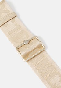 Beige fabric belt with embossed logo pattern, featuring a gold-tone metal buckle with a rectangular shape and a smooth texture.