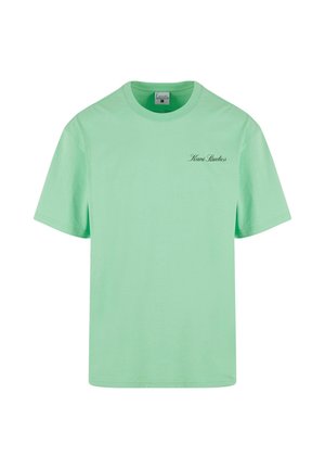 Mint green cotton T-shirt featuring short sleeves, crew neck, and a small black "Kani Studios" logo on the front left side.