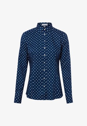 Marineblauw overhemd met lange mouwen, witte polkadots en een puntige kraag.