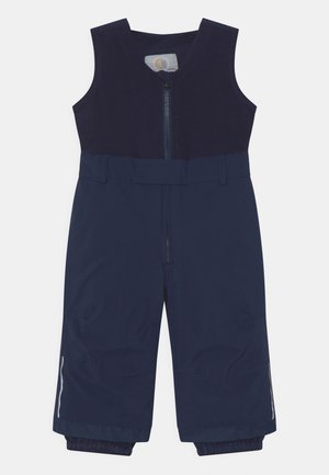 Salopette imperméable bleu marine avec fermeture éclair à l'avant, design sans manches, poignets élastiques aux chevilles et accents réfléchissants sur les côtés.