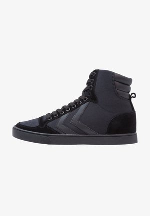 Black high-top sneakers featuring a mix of suede and fabric, textured panels, flat black laces, and a contrasting chevron design on the side.