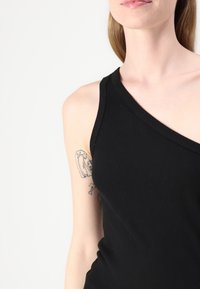 Black ribbed tank top with an asymmetric one-shoulder design. Made from stretchable fabric, showcasing smooth texture and fitted silhouette.