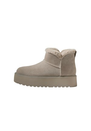 Short beige suede winter boot with thick sole and soft fur lining around the ankle, shown from the side on a white background.