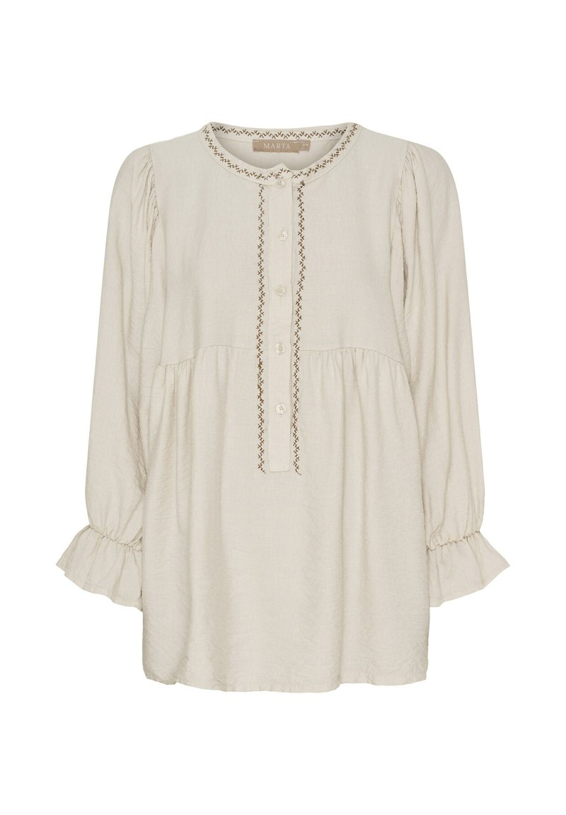 Lys beige langærmet bluse med rund halsudskæring, knaplukning og broderede detaljer ned ad fronten og ved ærmekanterne.