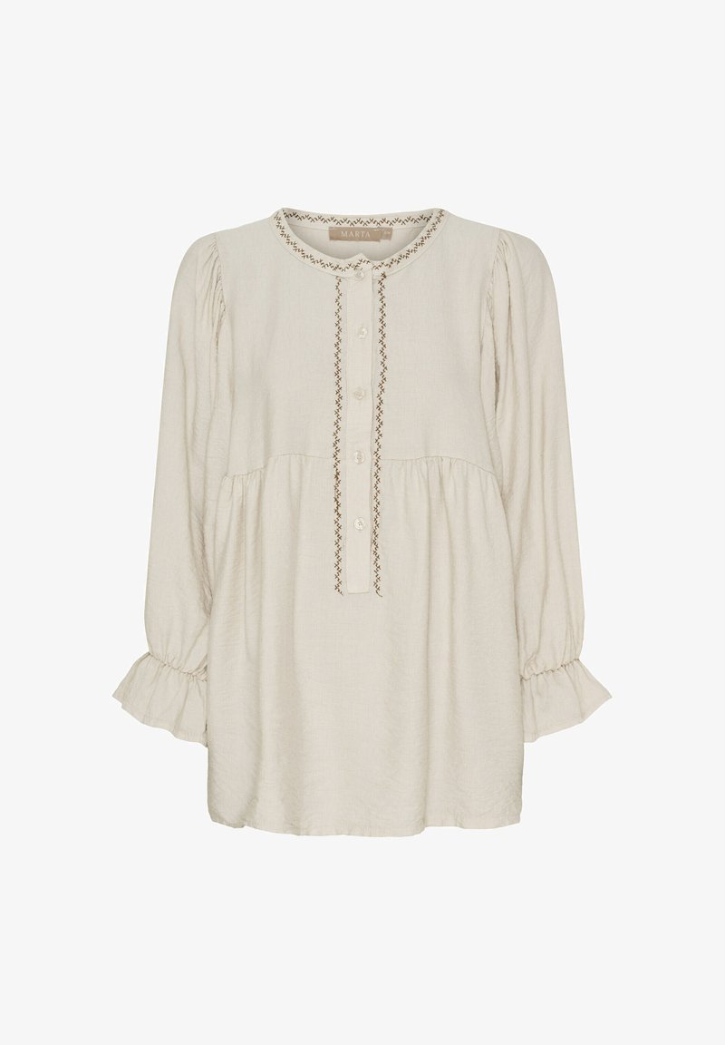 Lys beige langærmet bluse med rund halsudskæring, knaplukning og broderede detaljer ned ad fronten og ved ærmekanterne.