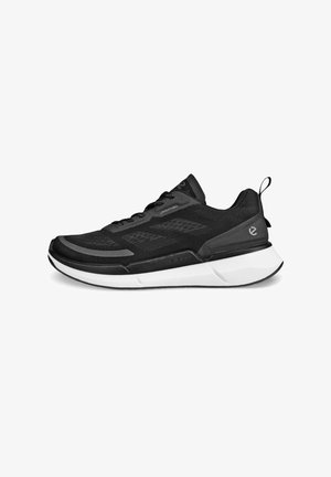 Black athletic shoe with a breathable mesh upper, textured design, rounded toe, and a contrasting white sole. Features laces and a pull tab.