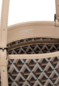 Beige læder tote taske med geometrisk mønster i brun og sort. Har en lynlåslomme og indvendig logoetiket.