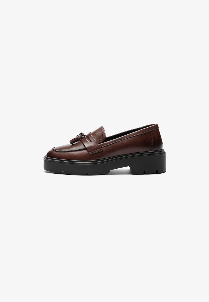 Brown leather loafer with a sleek design, contrasting black platform sole, and decorative tassel accent on the vamp. Smooth texture.