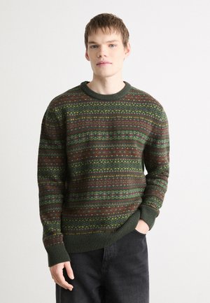 Knit sweater featuring a green base with colorful geometric patterns. The design includes stripes in red, yellow, and blue. Ribbed cuffs and neckline.