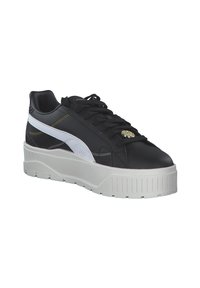 Sneaker in pelle nera con accenti bianchi e dettagli in oro, dotato di una suola bianca spessa e superficie testurizzata. I lacci sono neri.