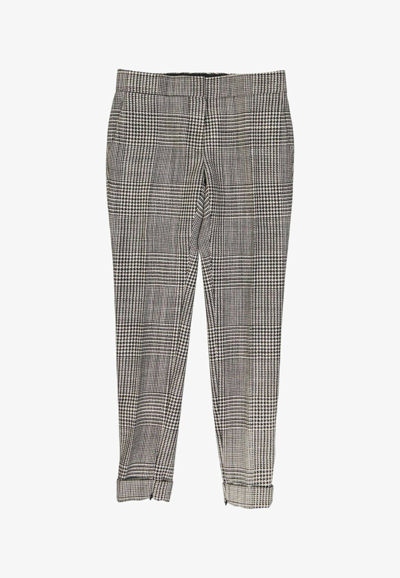 Pantalon slim à carreaux noir et blanc avec ourlets retournés et taille ajustée, présenté à plat sur fond blanc.