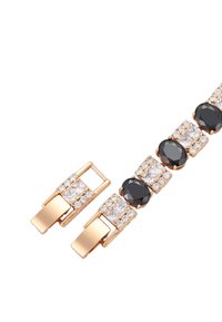 Bracciale in tonalità oro con gemme nere e trasparenti alternate, forme rettangolari e ovali, dotato di una chiusura sicura.