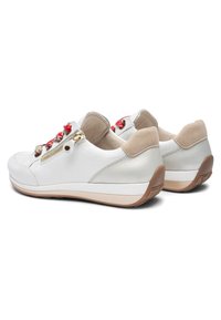 White leather sneakers with red laces, gold zipper on sides, beige suede heel tabs, and tan rubber soles shown from rear quarter angle.
