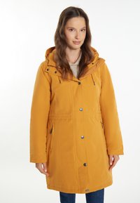 Žlutá bunda s kapucí, na zip a s patentky, s bočními kapsami a texturovanou látkou. Design je střední délky, s nastavitelným pasem.