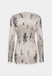 Top beige attillato a maniche lunghe con righe verticali e motivi floreali neri sparsi, visto da dietro.