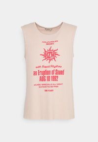 Sleeveless ribbed beige top with red text and sun graphic reading "Holzweiler presents an Eruption of Sound AUG 10 1992" on front.