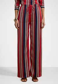 Red and navy striped wide-leg pants with an elastic waistband and drawstring, featuring thin off-white vertical lines.