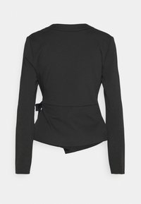 Veste blazer noire pour femmes, ajustée, à manches longues, avec un petit col et un détail de nœud sur le côté, vue de dos sur un fond blanc.