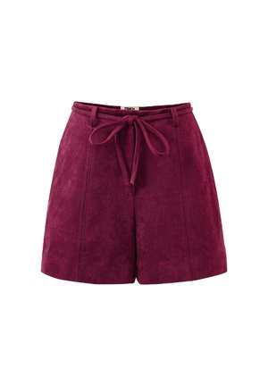 Hochtaillierte pflaumenfarbene Wildleder-Shorts mit Vordernähten, Gürtelschlaufen und einem gebundenen Stoffgürtel in der Taille auf weißem Hintergrund.