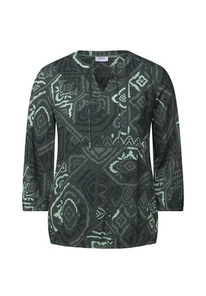 Tunique à manches longues de couleur vert foncé avec des motifs géométriques en menthe claire. Elle possède un col rond et une coupe décontractée. Texture de tissu douce.