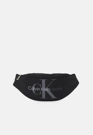 Schwarze Calvin Klein Jeans Bauchtasche mit Reißverschluss und großem "CK"-Logo vorne.