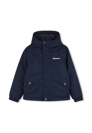 Veste enfant bleu marine à capuche avec poches à boutons-pression et logo Timberland sur la poitrine.