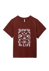 Camiseta de algodón marrón con un ajuste holgado, que presenta texto impreso en blanco: "SLOW LIFE" y elementos florales decorativos a su alrededor.