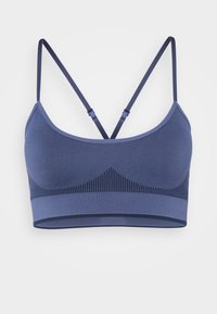 Navy blue sports bra featuring a seamless design, adjustable straps, and textured accents along the underbust. Soft, stretchy fabric.