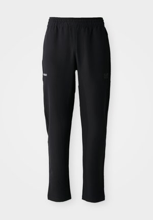 Black athletic pants with elastic waistband, side pockets, and subtle logo prints on thigh areas, displayed on white background.